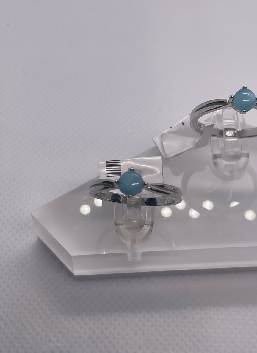 Pair of rings with blue gemstones on a white background