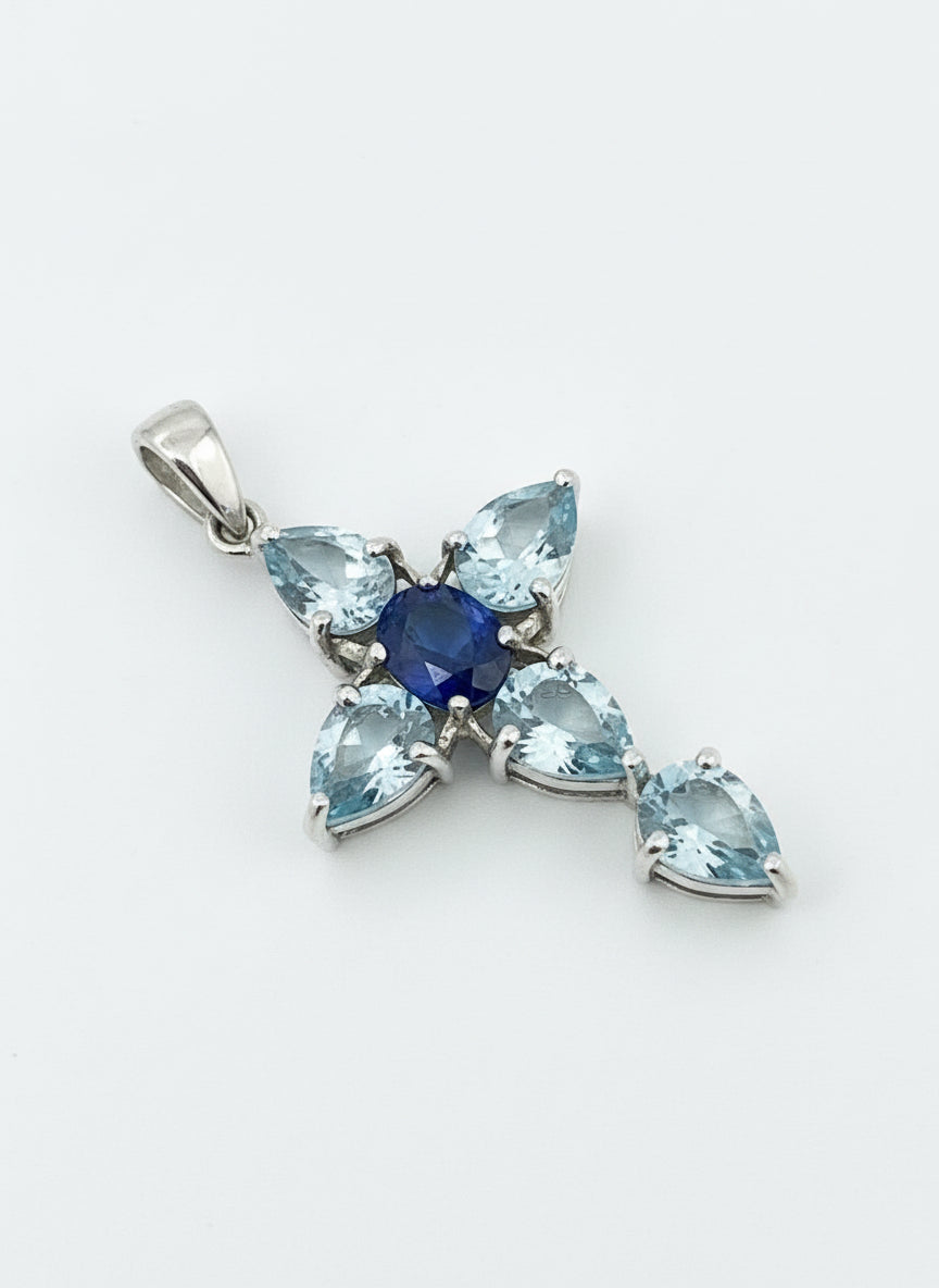 a blueish gemstone cross